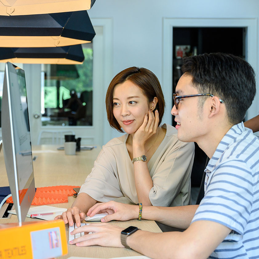 Man and Woman Looking at Computer